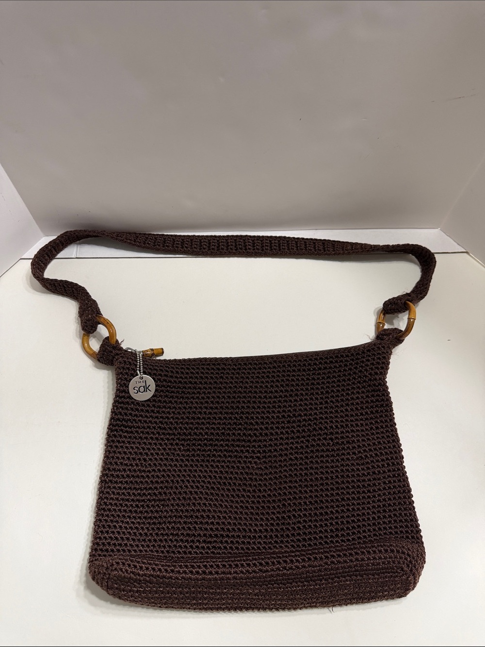 The Sak Dark Brown Crochet Crossbody Bag with Bamboo Rings